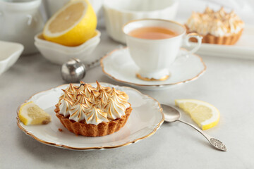 Meringue lemon tart on a white table.