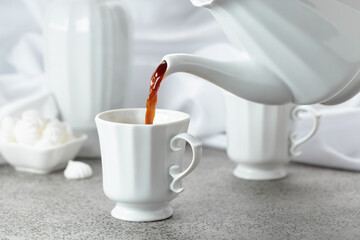 Black coffee in white porcelain cup and white small French meringues.