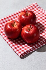 Three Vibrant Red Apples on a Red and White Checkered Cloth product mockup photo E-commerce marketing poster Background shooting scene