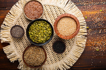 Pumpkin, sesame, flax, hemp, chia seeds in bowls, seeds for good health of mind and body, enriched...