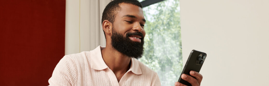 Smiling african american man enjoying his vacation in a stylish hotel room - Powered by Adobe