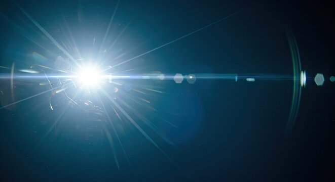 Bright White Starburst Effect on Dark Background with Blue Lens Flare