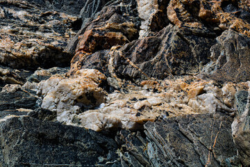 Close-up shot of quartz-infused geological rock texture on a wild Irish beach