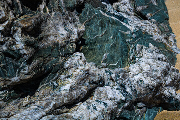 Close-up shot of igneous rock texture with quartz inclusions on a wild Irish beach