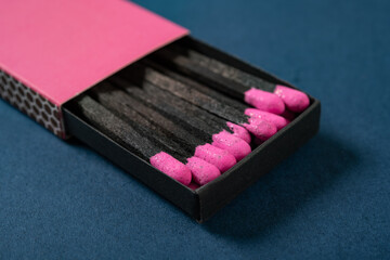 angle view pink matchbox on a blue background