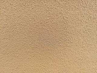 Close up of rough beige plaster wall with textured surface