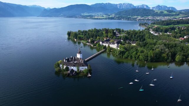Austria Schloss Ort castle on Traunsee lake aerial view in Gmunden town Salzkammergut region Alpine landscape with wooden bridge 4k cinematic drone footage travel destination scenery Upper Austria