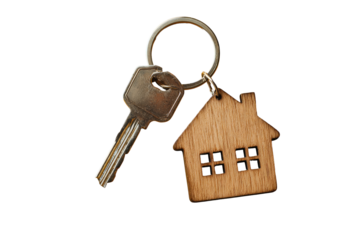 Metal key attached to a wooden house keychain