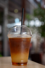 cold coffee with orange juice in a clear glass