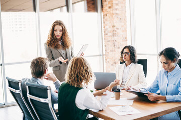 Business team collaborating in a modern office setting, discussing a project with leadership and teamwork showcasing professionalism