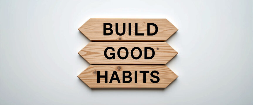 motivational wooden arrow signs with build good habits message on white background