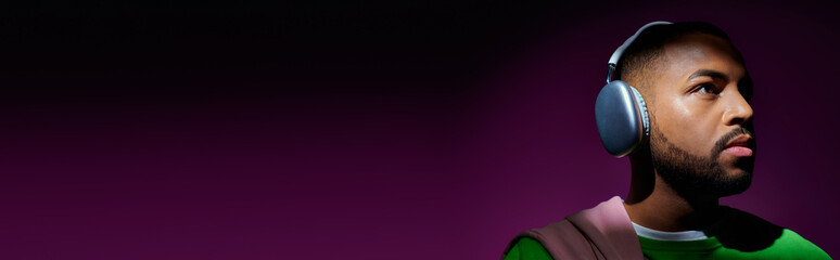 Stylish young man wearing headphones enjoys music in a vibrant urban setting