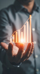 Digital business growth visualization Hand holding glowing bar chart data