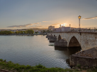 Stone bridge over the Tua River in Mirandela, Portugal, with granite arches and pedestrian use. August 2025, peaceful historic landmark connecting old city sides.
