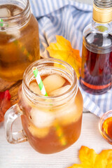 Sweet refreshing Maple Iced Tea Drink, tasty aromatic cold beverage with ice cubes and a lot of maple syrup, copy space