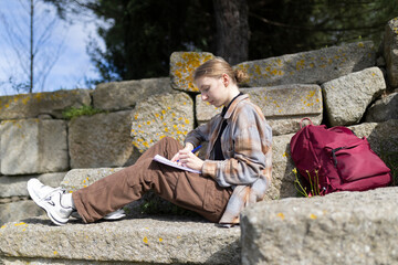 Archaeologist writing notes at excavation site