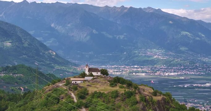 Drone view over Etschtal toward Merano with St Hippolyt church