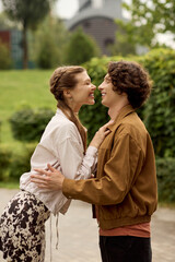 Loving couple shares a joyful moment while walking together in a beautiful park