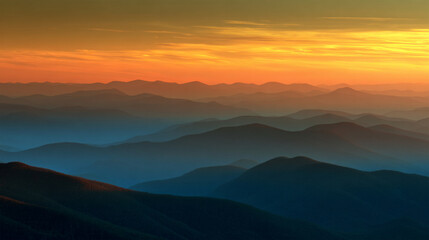Fototapeta premium Sunset over layered mountain ridges with colorful sky 