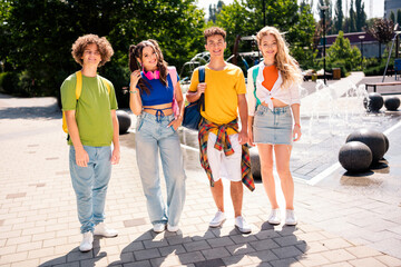 Group of young friends enjoying an outing in a city park on a sunny day showcasing togetherness and cheerful energy