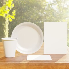 Dining table setting standing on wooden table. Dinner disposable tableware mockup: napkin invitation white plate paper cup. Outdoors green nature background. Lush trees leaves environment.