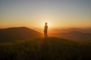 Fototapeta premium Hiker Standing on Hilltop During Sunset
