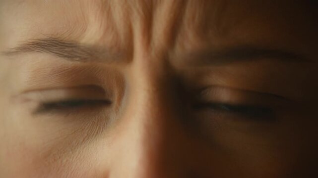 Woman expressing intense disgust, furrowing brow and squinting, revealing deep aversion and repulsion