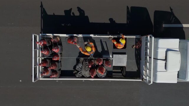 Workers Operating Machinery Applying Asphalt on Road Construction