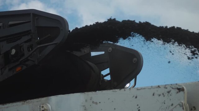 Workers Operating Machinery Applying Asphalt on Road Construction