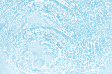 Blue water with ripples on the surface. Defocus blurred transparent blue colored clear calm water surface texture with splashes and bubbles. Water waves with shining pattern texture background.