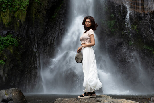Woman at Gitgit waterfall in Bali , Singaraja, Indonesia