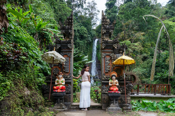 Woman at the entrance of Gitgit waterfall in Bali , Singaraja, Indonesia