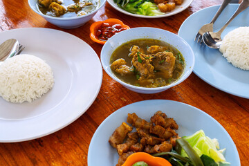 Balinese lunch with rice, fried pork and soup, Denpasar Bali