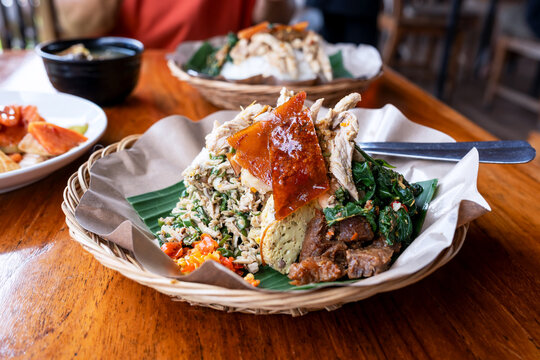 Roasted pork with rice and vegetables or nasi campur babi guling Balinese food;