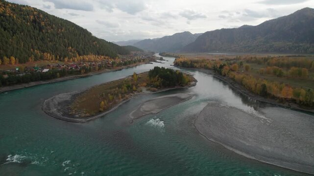 Aerial view of autumn Altai mountains, Chemall village and Katun river captured by a drone
