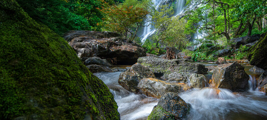 Fototapeta premium Beauty in nature, amazing waterfall in tropical forest of national park, Klonglan waterfall, Thailand 