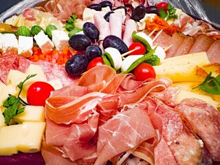 Assorted meat and cheese platter with fruits and vegetables