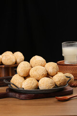 Golden Round Cookies on Rustic Wooden Board with Milk Glass Traditional Homemade Dessert