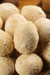 Fresh Golden Brown Mushrooms with Natural Dusty Skin Texture in Wooden Bowl