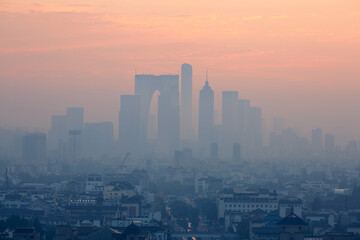 Suzhou city CBD and traditional residential buildings in morning fog, China