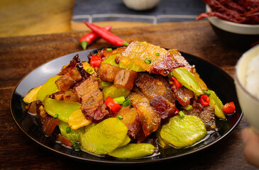 Stir-Fried Lettuce with Bacon and Vegetables on Black Plate