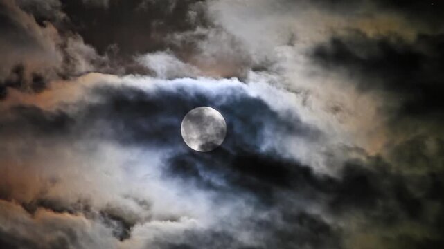 Mysterious view of the full moon partially dimmed by penumbral eclipse, surrounded by colorful dramatic clouds.