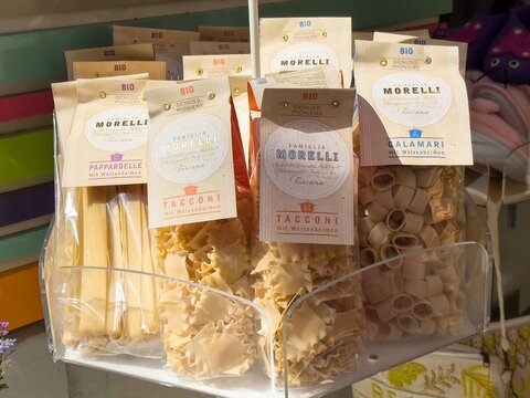 Graz, Austria - September 06, 2025: Assorted organic pasta varieties displayed in a market, featuring Morelli brand packaging, showcasing traditional Italian craftsmanship and vibrant colors