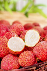 Fresh Lychee Fruit in Basket on Wooden Table with White Flesh Exposed