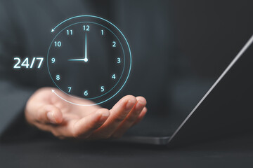 Nonstop service concept. Businesswoman hand holding virtual 24-7 with clock on hand for worldwide nonstop and full-time available contact of service concept. Customer service.