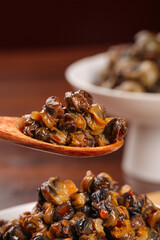Spicy Stir-Fried Whelk Meat in Wooden Spoon - Traditional Asian Seafood Dish