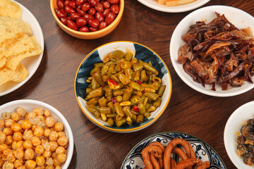Traditional Chinese Appetizers with Pickled Vegetables Beans and Snails on Wooden Table