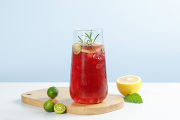 Fresh Red Fruit Juice Cocktail with Herbs and Citrus on Wooden Board - Summer Refreshing Drink