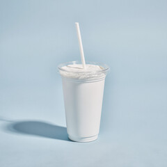 Plain white soda cup with a clear lid and straight straw on a pastel blue background, minimal studio composition with soft halo shadow