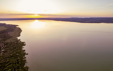Spectacular sunset over lake Balaton with golden reflections, Hungary.